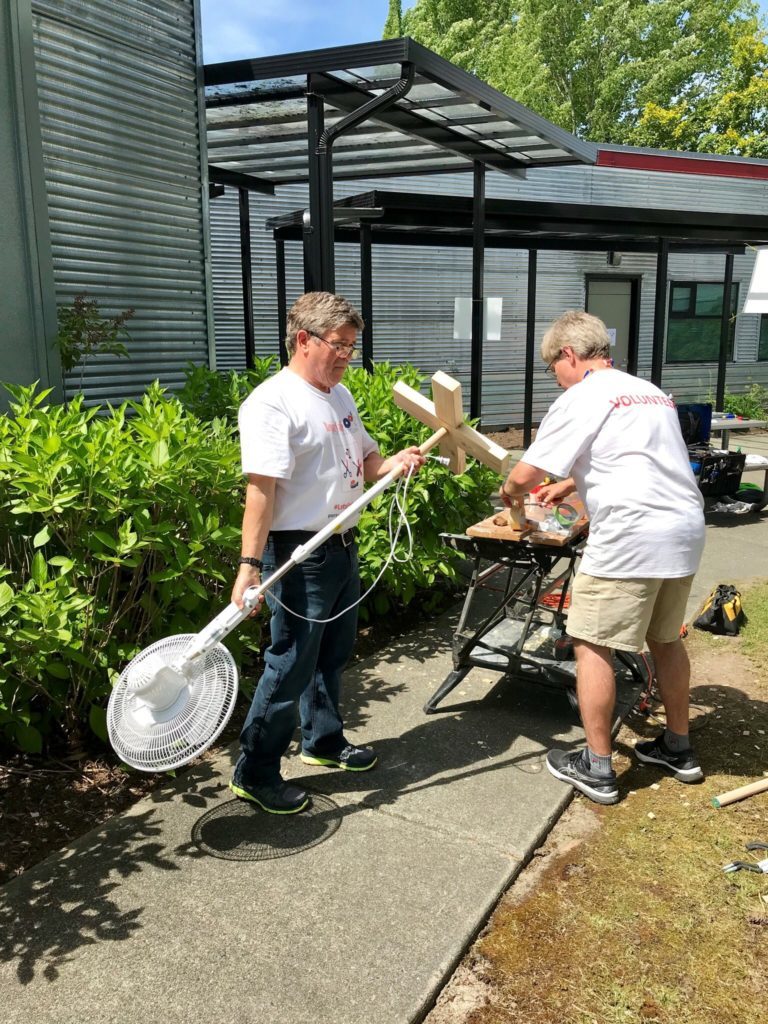 Two volunteers repairing a fan at the Port Coquitlam Repair Cafe