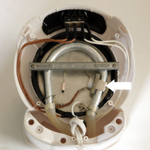 Inside of drip coffeemaker, showing the switch (top), water passages and heating element, and thermostat. Water flows (or flowed -- until this unit stopped working) from the reservoir through tube on left and up to the coffee basket through tube on right. licensed under the Creative Commons Attribution-Share Alike 3.0 Unported license.